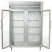 A large stainless steel Traulsen reach-in refrigerator with two glass doors on white shelves.