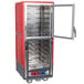 A red and silver Metro C5 heated holding and proofing cabinet with clear Dutch doors open.