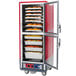 A red and silver Metro C5 heated holding and proofing cabinet with trays of food inside.