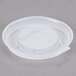A close-up of a translucent plastic lid with a white lid on top.