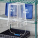 A clear plastic Vigor ice tote with a clear lid on a shelf.