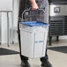 A man using a Vigor square ice tote to carry ice.
