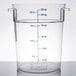 A Carlisle clear round plastic food storage container with a measuring line.