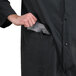 A man wearing a black Cordova rain coat with a pocket.