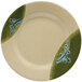 A white melamine plate with a green and blue Japanese design on the rim.