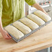A Baker's Mark bread loaf pan with dough for 5 loaves.
