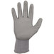 A close-up of a small grey Ergodyne ProFlex 7024 cut resistant glove with a white palm.