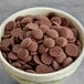 A bowl of Ghirardelli 72% Non-Dairy Dark Chocolate baking chips.