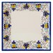 A white square melamine plate with a blue and yellow floral design.