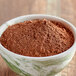 A bowl of Ghirardelli Superior Dutch cocoa powder.