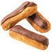 Three Rich's New York Style Chocolate-Iced Bavarian Cream-Filled Eclairs on a white background.