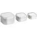 A group of silver square tins with white slip covers.