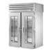 A silver True Spec Series roll-through refrigerator with glass and solid doors.