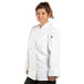 A woman wearing a white Uncommon Chef long sleeve chef coat.