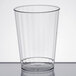 A WNA Comet clear plastic fluted tumbler on a table.