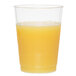 A WNA Comet Classicware clear plastic fluted tumbler filled with orange juice on a white background.