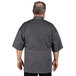 A man wearing a slate grey Uncommon Chef Venture Pro chef coat with short sleeves and a mesh back.