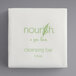 A white square with green text that says "Nourish Spa Cleanse"