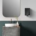 A Kimberly-Clark Professional ICON automatic soap dispenser with a black mosaic faceplate next to a bathroom sink with a mirror above it.