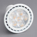 A close-up of a TCP dimmable LED spotlight with a round GU10 base emitting white light.