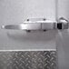 A stainless steel door handle on a metal surface.
