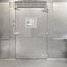 The stainless steel door of a Bally walk-in cooler.