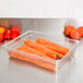 A clear plastic food pan with carrots in it.