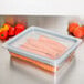 A Cambro clear plastic food pan with carrots in it.