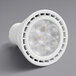 A TCP dimmable LED light bulb with a round GU10 base shining white light.