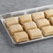 A tray of square brown Orange Bakery butter flake rolls.