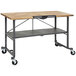 A black and gray Cosco SmartFold portable work table with wheels.