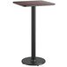 A Lancaster Table & Seating bar table with a black metal base.