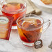 A glass mug of Twinings Ceylon Orange Pekoe tea with a bag of tea.