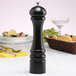 A black Chef Specialties pepper mill on a table.