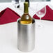 A Vollrath wine bottle in a silver wine cooler.