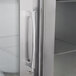The left hinged glass door of a Traulsen reach-in refrigerator.