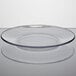 An Anchor Hocking clear glass plate with a clear rim on a white surface.