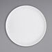A white Cal-Mil melamine plate with a low circular rim.
