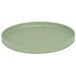 A green round Cal-Mil Melamine plate with a low rim.