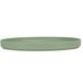 A green Cal-Mil Hudson melamine plate with a small rim on a white surface.