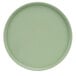 A close-up of a green Cal-Mil Hudson melamine plate with a low rim.
