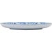A white coupe melamine plate with blue and white designs.