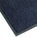 A close-up of a slate blue Notrax carpet entrance mat with a black border.