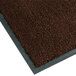 A brown Notrax carpet entrance mat with a gray border.