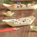 EcoChoice disposable wooden food boats filled with sushi on a table.
