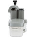 A Robot Coupe vegetable prep attachment for a food processor with two blades and a lid.