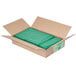 A cardboard box with green plastic trash can liners.