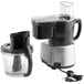 A black and silver Waring food processor with a clear bowl.
