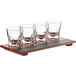 An Acopa wood tray with four 4.5 oz. espresso glasses.