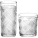 Two Acopa Zion cocktail glasses with a pattern on them.